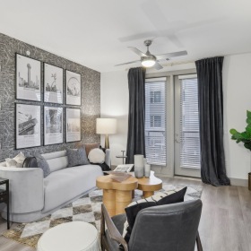 Living area with large windows and hardwood floors Living area with large windows and hardwood floors