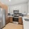 Kitchen with gray and wood cabinets and wood-style flooring